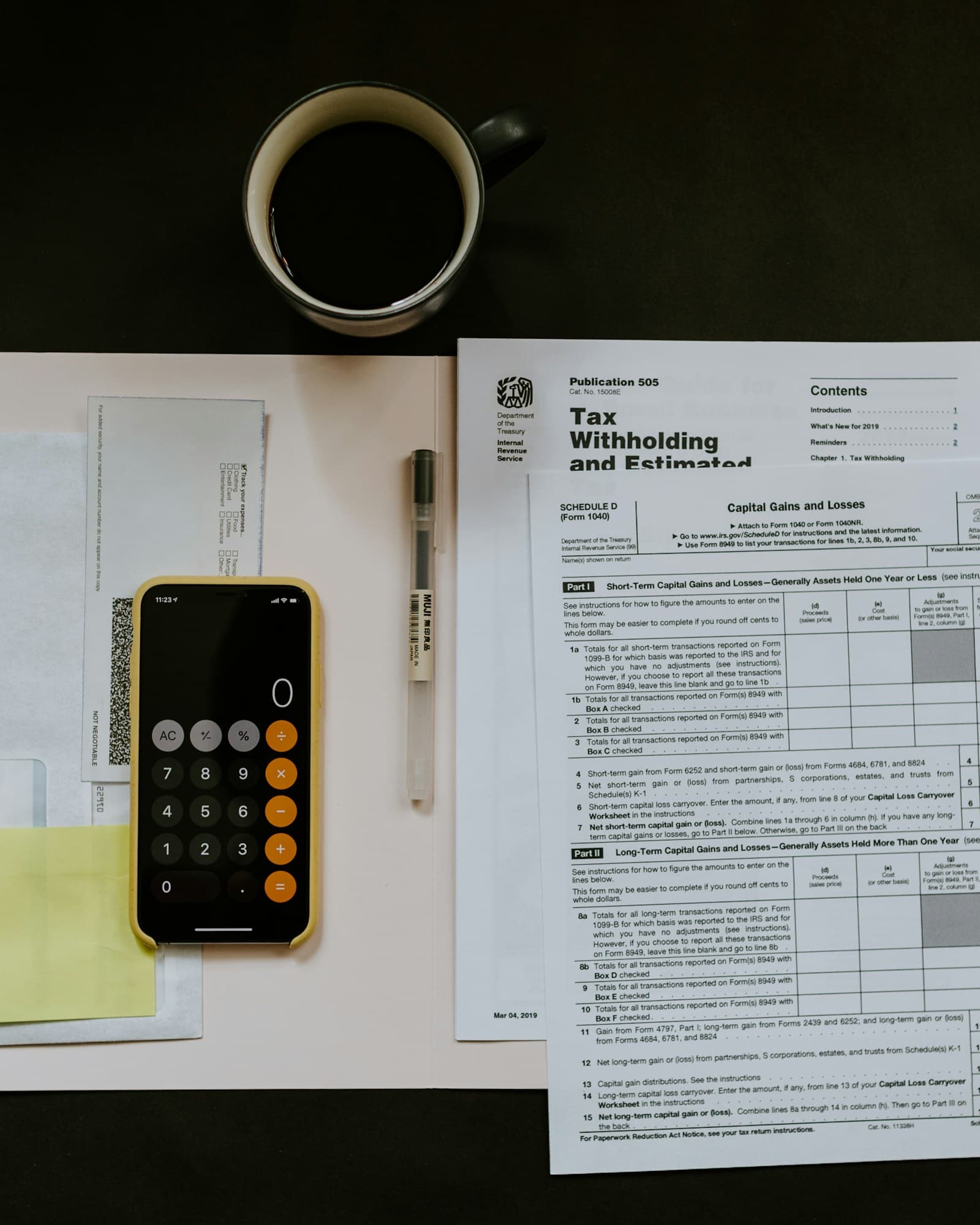 Invoices, a calculator and a phone on a desk
