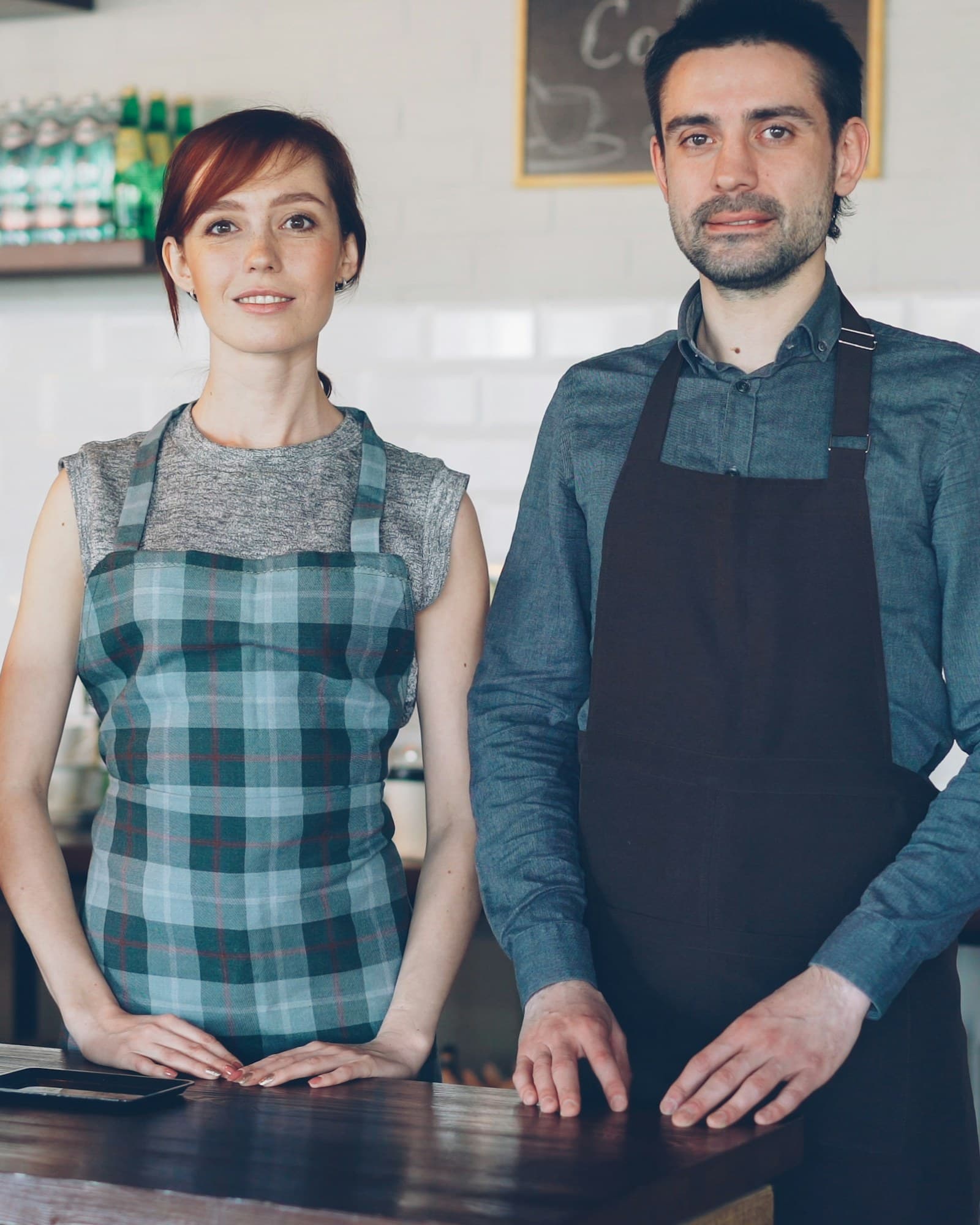 Two café owners behind their counter